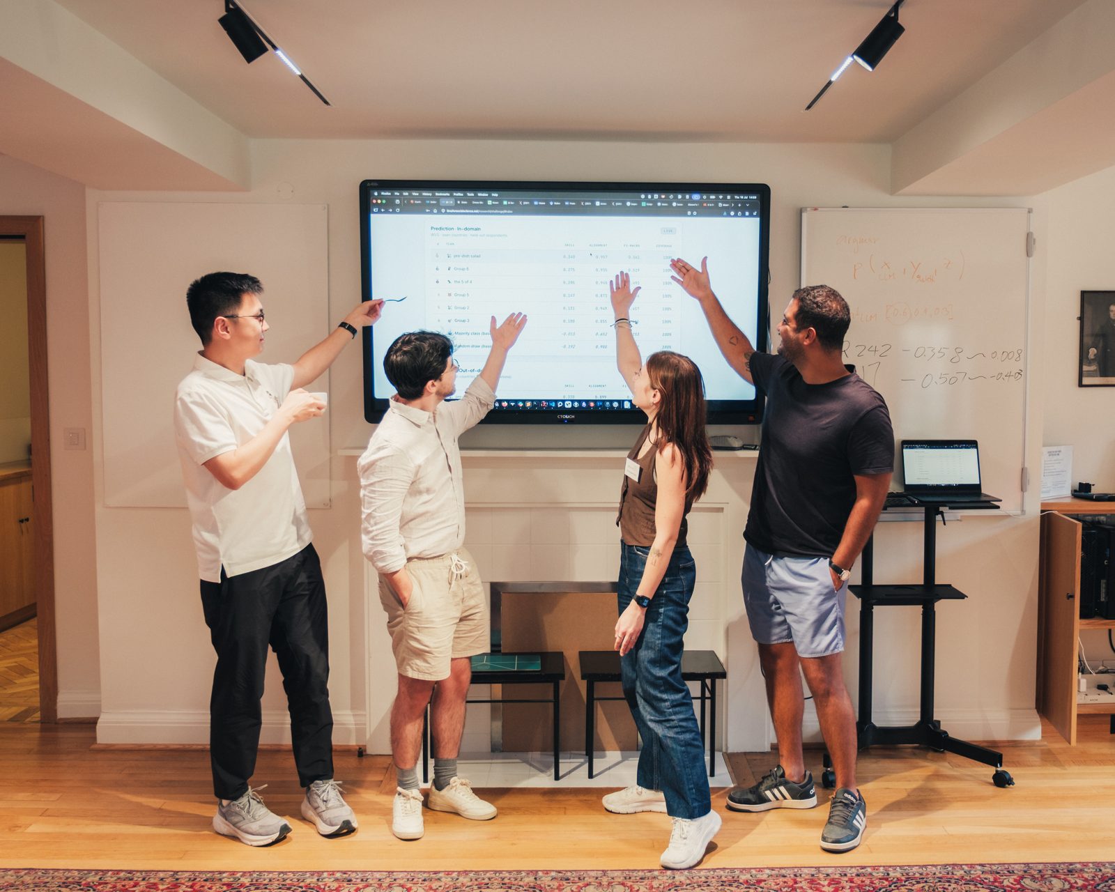 A team presenting their method at the final session, leaderboard on screen