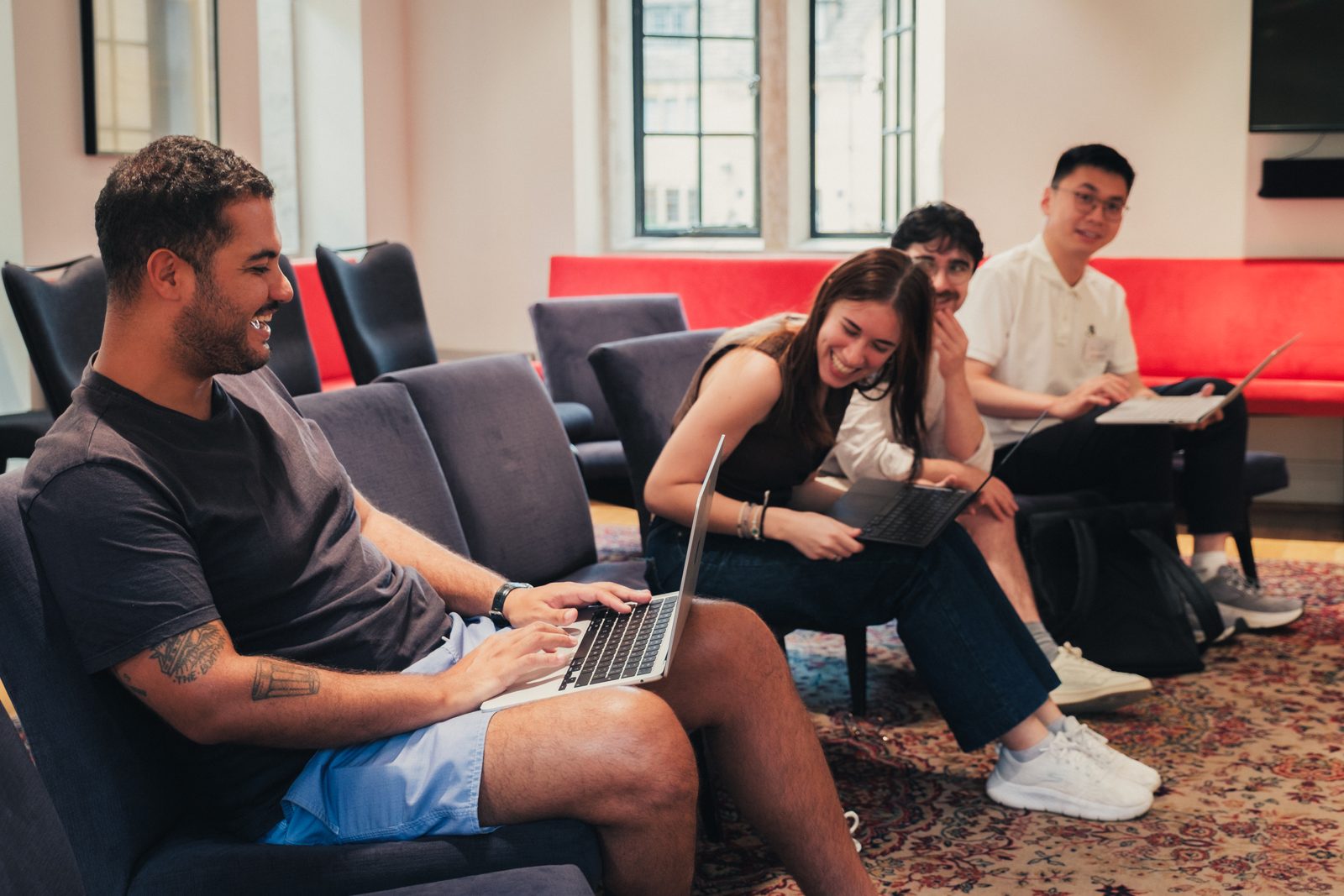 Participants working and talking informally in a college common room