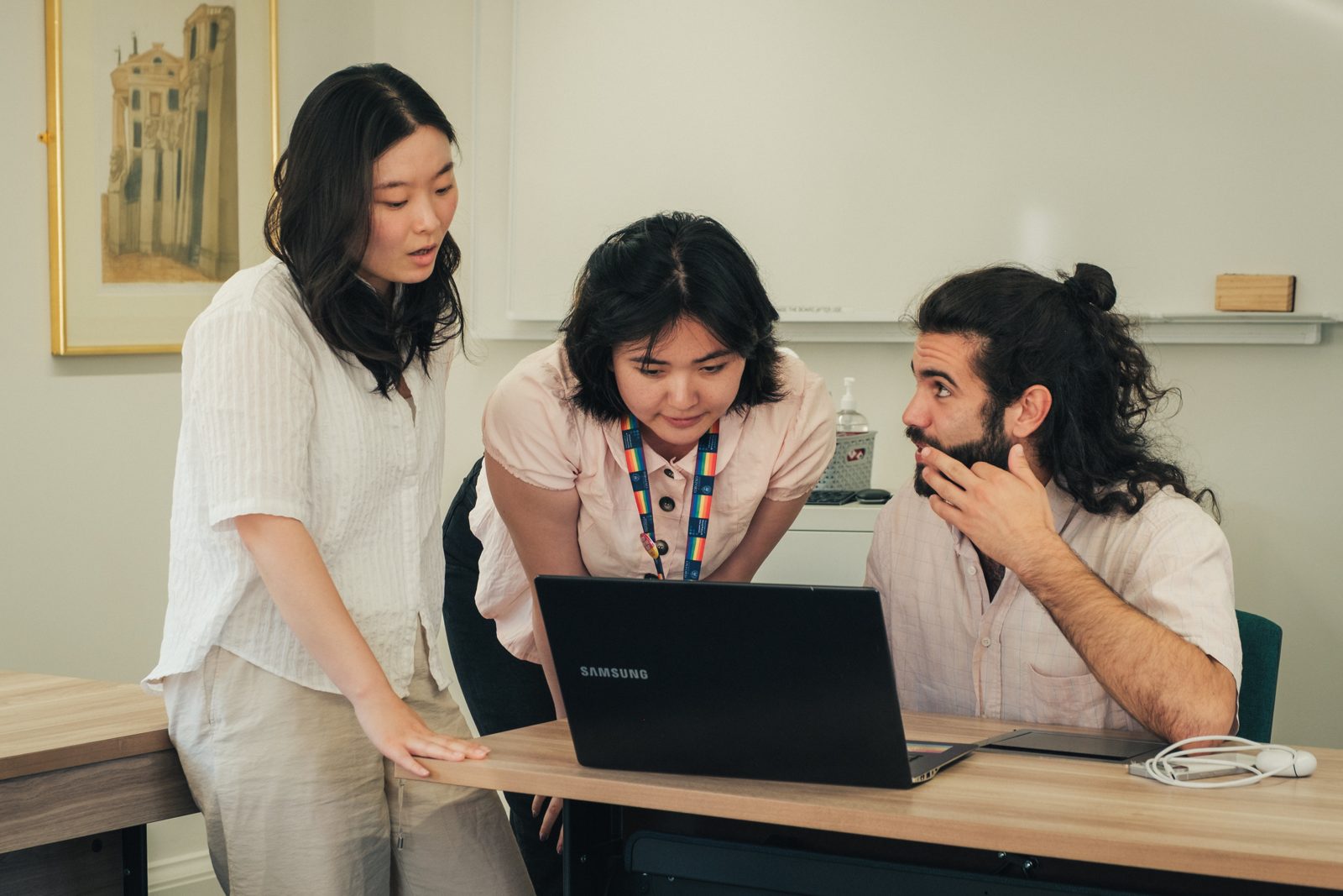 Three participants working together at a laptop during the research project